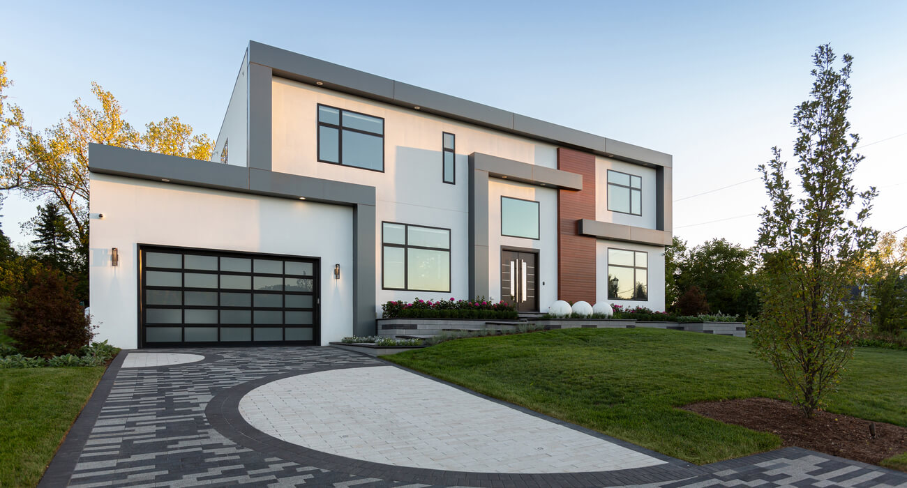 Custom paver driveway featuring unique shapes and textures, providing durable, attractive access to contemporary residence.